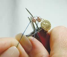Beads and thread in knotting tool